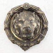 Large brass door knocker in the form of a lions head
