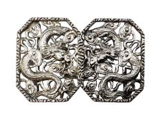 A Chinese silver two part buckle with stylised dragon decoration by Hung Chong and CO Hong Kong