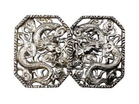 A Chinese silver two part buckle with stylised dragon decoration by Hung Chong and CO Hong Kong