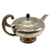 A sterling silver tea pot of bulbous form with fruit wood handle by John Roberts, Sheffield. 1912.