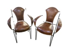 Pair leather and steel chairs. Possibly Jacque Adnet. Brass finials and leather stitching. Wear