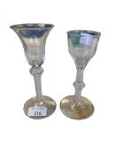 Two C18th spiral stem wine glasses, the smaller with chip to rim, 15 cm (tallest) and three later