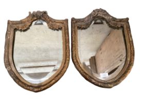 A pair of antique shield shaped gilt frame mirrors, originally from a house in Ireland, some wear