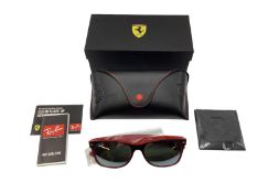 A pair of Ray-Ban Ferrari sunglasses in black and red stitched case with unopened wipe, paperwork,