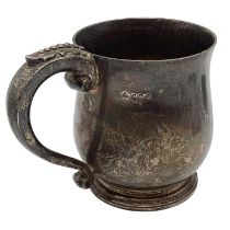 A sterling silver mug, loop handle and circular stepped base by Elkington and Co Birmingham 1931,