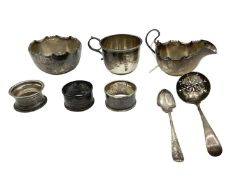 A collection of 8 sterling silver items to include christening cup, sugar bowl, napkin rings and