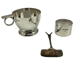 A collection of sterling silver items to include a christening cup napkin ring, pap spoon, various