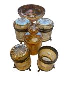 Collection of amber glass items to include gilt brass mounted lidded jars and opalescent taza