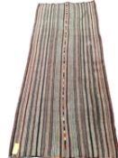 A Kilim style rug/runner with all over stylized reds and greys stripes, 133/310cm