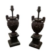 A pair of good heavy classical style spelter urn shaped lamps on square marble plinth bases 45 cm