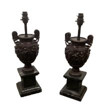 A pair of good heavy classical style spelter urn shaped lamps on square marble plinth bases 45 cm