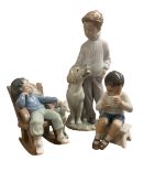 Royal Copenhagen figure of a seated boy, and two Lladro figures