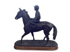 EMMA MACDERMOTT, A bronze statue of racehorse and jockey on wooden plinth, plaque to base " UNITE,