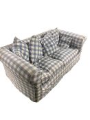 A pull out sofa bed, with loose covers in a blue chequered pattern. With wear, from a clean house.