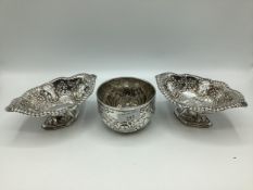 A pair of sterling silver pierced dishes on stepped feet together with a sterling silver bowl with