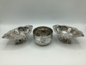 A pair of sterling silver pierced dishes on stepped feet together with a sterling silver bowl with