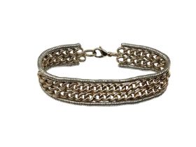 A 9ct yellow and white gold flat belt link bracelet. Approx 17cm. 32g.