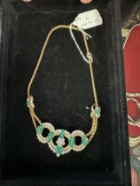 An 18ct gold Emerald and diamond necklace. Retailed by Asprey's . Three articulated open work