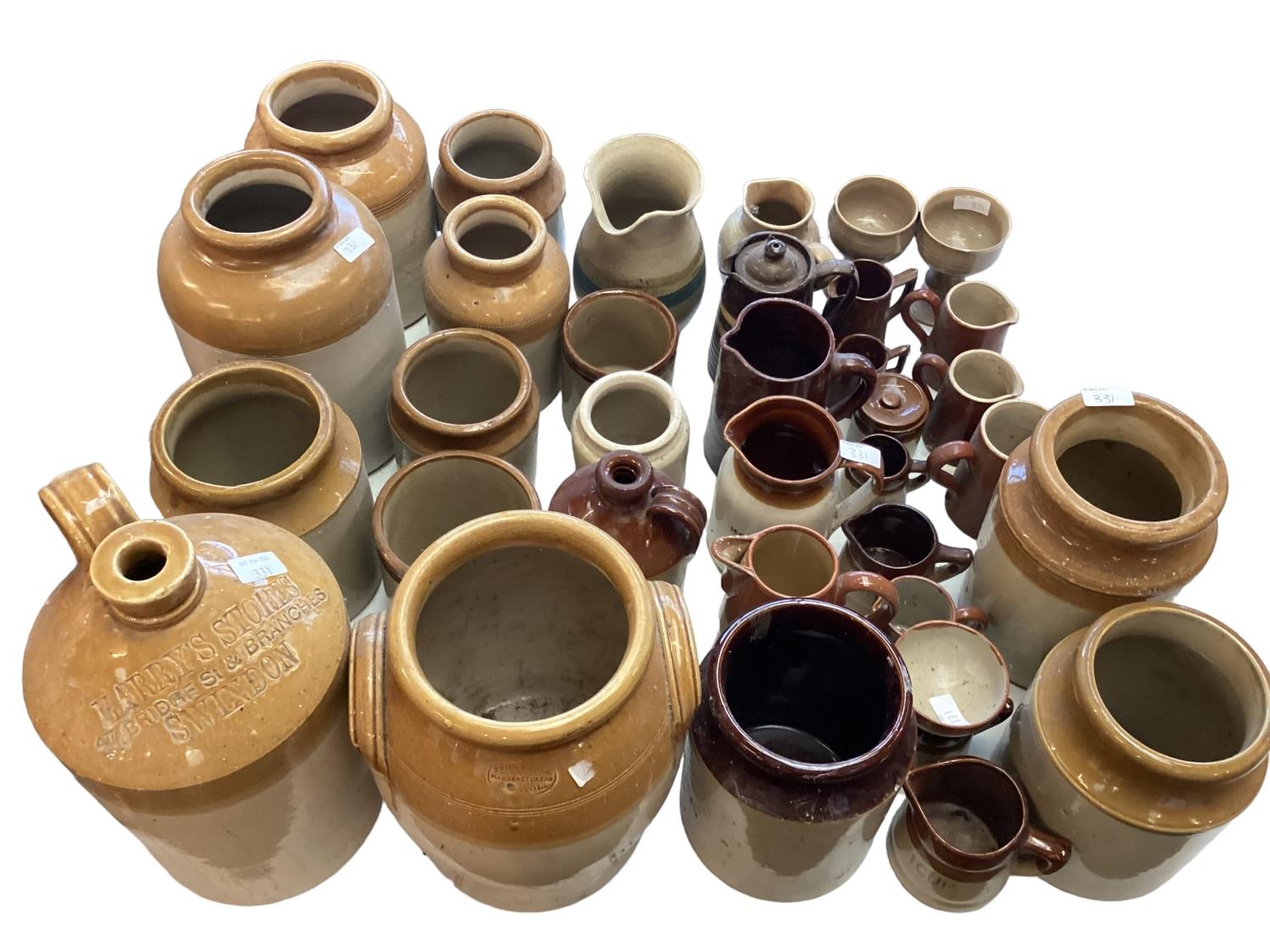 A quantity of brown earthenware pottery jugs and pots and flaggons, all as found