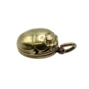 An unmarked yellow metal (possibly 14ct+ gold) scarab beetle memorial locket. Opening to reveal