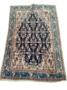 A Persian style rug, with blue border, and central medallion of dark blue ground with pink/cream and