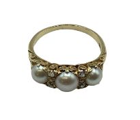 An 18 ct gold pearl and diamond set ring, 3 half pearls with old cut diamond separators to a