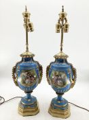 A pair of Continental Meissen Style lamps, on stepped gilded base, the blue body with central oval