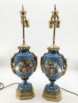A pair of Continental Meissen Style lamps, on stepped gilded base, the blue body with central oval