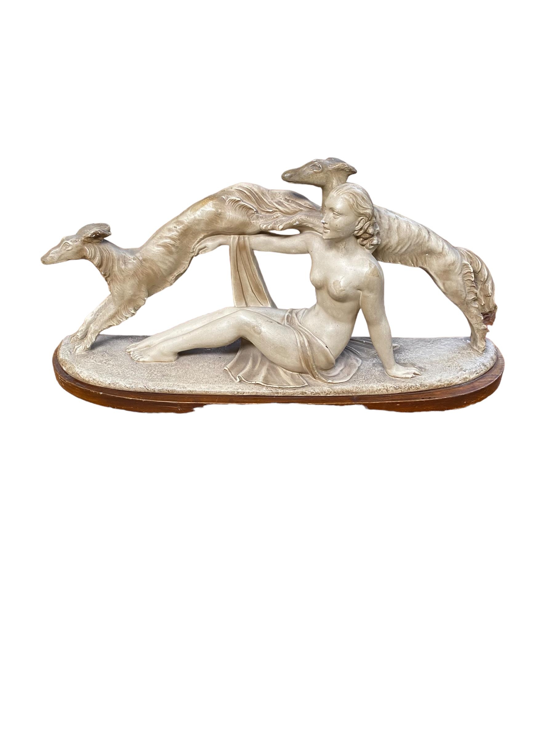 A modern composite statue of a reclining female nude, with two lurcher/hounds, as found with some - Image 2 of 3
