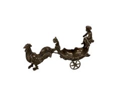 A small silver model of a chariot and cherub, being pulled by a chicken