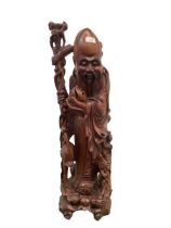 A Chinese Carved Hardwood figure of Shou Lao (the god of longevity), early to mid C20th, carved from