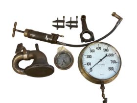 A circular brass dial PRESSURE GUAGE, labelled BUDENBERG, Broadheath Manchester; a CAR CLOCK,