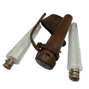 Ladies tan leather hunting saddle flask with two conical glass flask