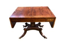 A Regency Brass inlaid kingwood sofa table on square column supports quatrefoil base wit