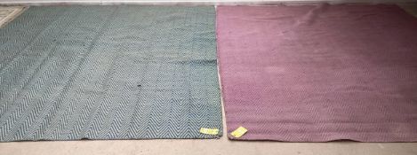 Two modern rugs, in green and blue chevron pattern, and a similar one in pink, both with wear in