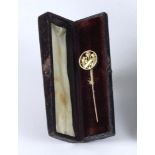 Cricket stick pin. A Victorian gold lapel stick pin with ornate circular head with array of pads,