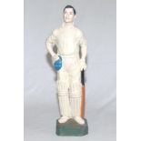 Cricket figure c.1950s. A painted plaster figure of a batsman standing full length on a green