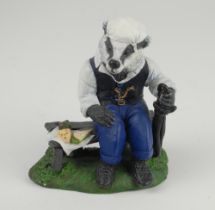 ‘The Badger Spectator’. A handmade and painted figure of a ageing badger sitting on a bench, with