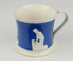Staffordshire blue ground waisted cricket mug with strap handle and beaded rim. With three relief