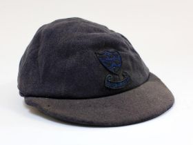 Sussex navy blue 1st XI cloth cricket cap worn by Robin Marlar during his playing career. The cap,