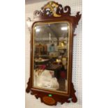 A Chippendale style mahogany fret-cut and gilt decorated bevelled rectangular wall mirror, 91 x 49cm