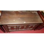 An 18th century joined oak three-panelled hinge top coffer, having floral relief carved and