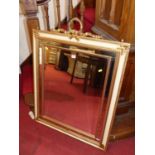 A contemporary French style cream and gilt framed bevelled rectangular mirror, with ribbon