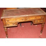 A Victorian mahogany rexine and studded inset kneehole writing table, having an arrangement of