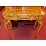 An early Georgian style figured walnut and cross banded shaped top fold-over baize lined card table,