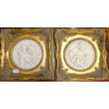 A pair of reproduction alabaster relief plaques, dia.17cm, each in gilt composition frames