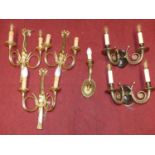 A collection of various contemporary gilt brass wall lights to include; mostly twin branch