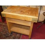 A beech and brass bound butcher's block on stand, the two-tier stand with single upper drawer and on