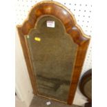 An early Georgian style walnut and gilt decorated cushion framed arched bevelled wall mirror, 75 x