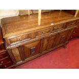 A 1930s geometric moulded oak double door sideboard, having twin frieze drawers, width 137cm